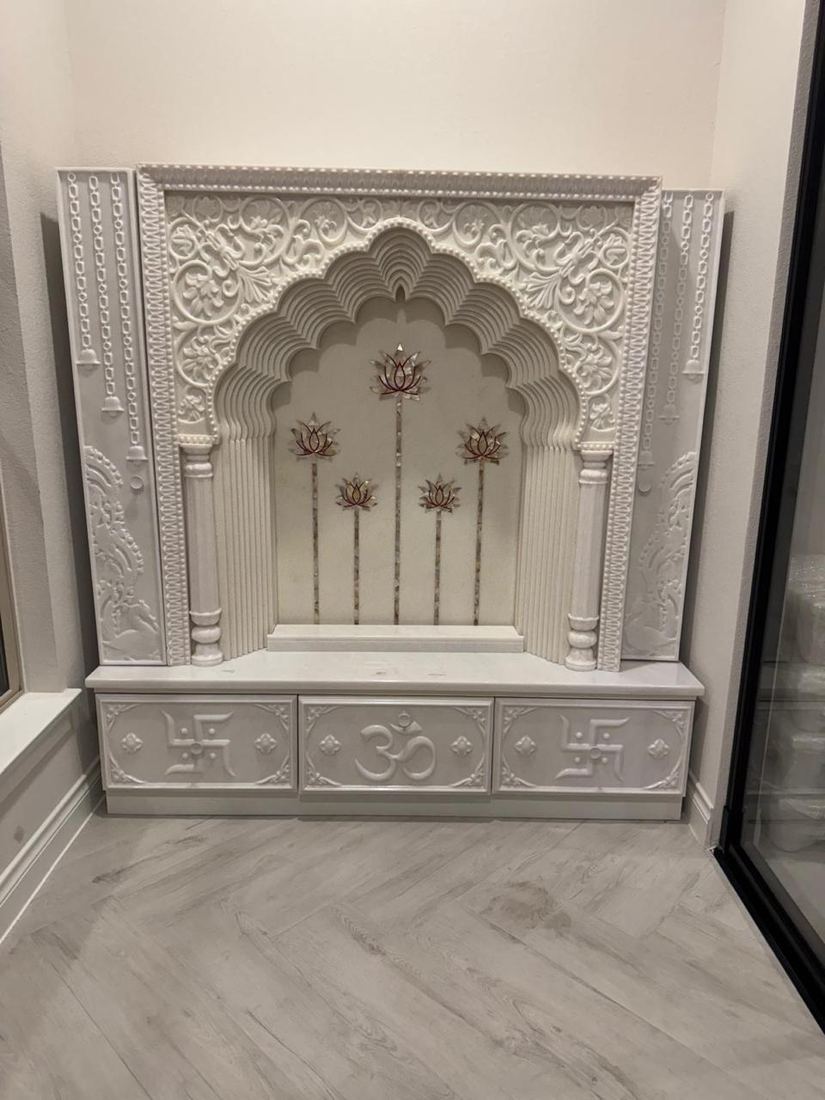 Carved white home temple with lotus details