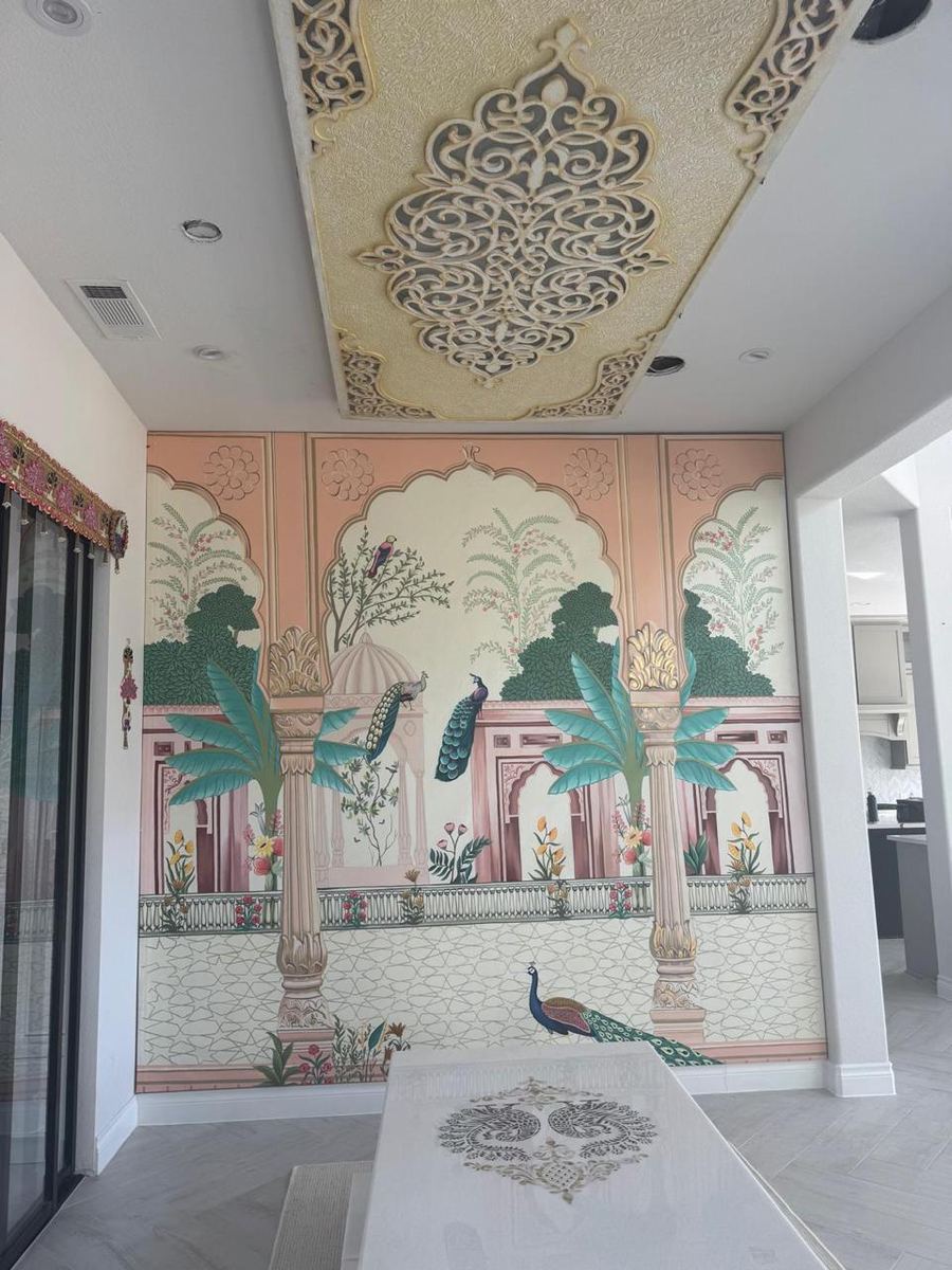 Hand-painted palace mural with peacocks beneath a carved ceiling panel